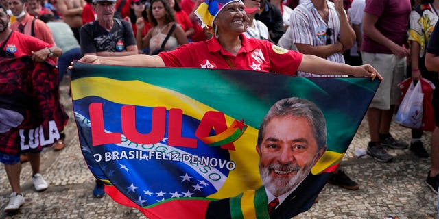 A supporter of Luiz Inacio Lula da Silva displays a banner during his inauguration as new president outside the Planalto presidential palace in Brasilia, Brazil, Sunday, Jan. 1, 2023. 