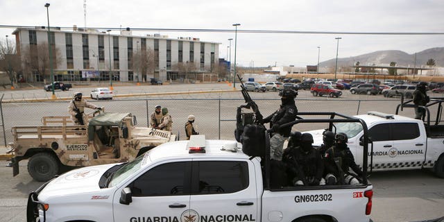 Mexican National Guard stand guard outside a state prison in Ciudad Juarez, Mexico, Sunday Jan 1, 2023. Mexican soldiers and state police regained control of a state prison in Ciudad Juarez across the border from El Paso, Texas after violence broke out early Sunday, according to state officials. 