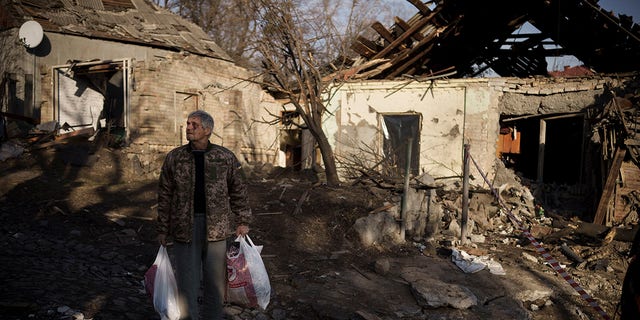 Anatolii Kaharlytskyi, 73, stands near his house, heavily damaged after a Russian attack in Kyiv, Ukraine, on Jan. 2, 2023. Kaharlytskyi was injured and his daughter-in-law Iryna died in the attack on Dec. 31, 2022. (AP Photo/Renata Brito)