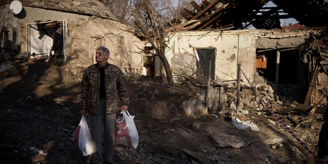 Anatolii Kaharlytskyi, 73, stands near his house, heavily damaged after a Russian attack in Kyiv, Ukraine, on Jan. 2, 2023. Kaharlytskyi was injured and his daughter-in-law Iryna died in the attack on Dec. 31, 2022. (AP Photo/Renata Brito)