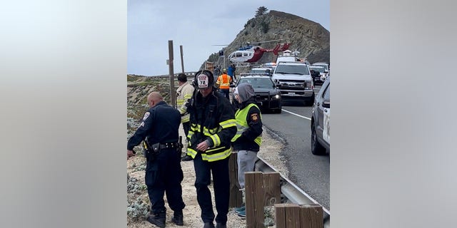 Emergency personnel respond after a Tesla plunged off a Northern California cliff along the Pacific Coast Highway, Monday, Jan. 2, 2023, near an area known as Devil's Slide, leaving four people in critical condition, a fire official said.