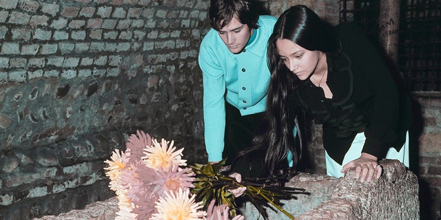 Leonard Whiting and Olivia Hussey, playing the title roles in Franco Zeffirelli's "Romeo and Juliet," place flowers on the Tomb of Juliet, in Verona, Italy, on Oct. 22, 1968.