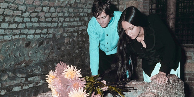 Leonard Whiting and Olivia Hussey, playing the title roles in Franco Zeffirelli's "Romeo and Juliet," place flowers on the Tomb of Juliet, in Verona, Italy, on Oct. 22, 1968.