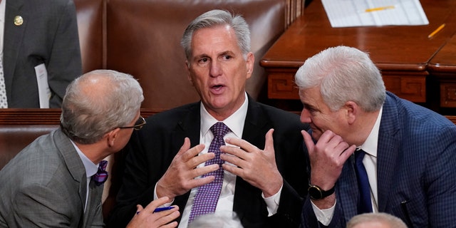 Rep. Patrick McHenry, RN.C., left, and Rep. Tom Emmer, R-Minn., right, speak with Rep. Kevin McCarthy, R-Calif., in the House chamber as the House meets for a second day to elect a speaker and convene the 118th Congress in Washington, Wednesday, Jan. 4, 2023. 