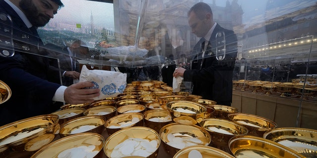 Holy communion vessels are filled ahead of the funeral mass for late Pope Emeritus Benedict XVI in St. Peter's Square at the Vatican, Thursday, Jan. 5, 2023. Benedict died at 95 on Dec. 31 in the monastery on the Vatican grounds where he had spent nearly all of his decade in retirement. 