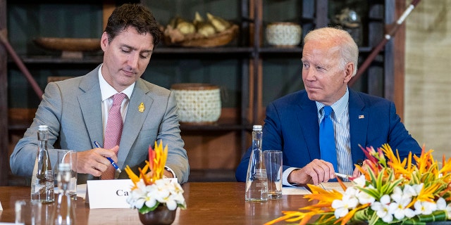 President Joe Biden, right, and Canadian Prime Minister Justin Trudeau attend a meeting of G7 and NATO leaders in Bali, Indonesia, Nov. 16, 2022.