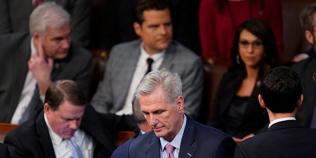 Rep. Kevin McCarthy, R-Calif., walks back to his seat after speaking with Rep. Matt Gaetz, R-Fla., after Gaetz voted "present" in the House chamber as the House meets for the fourth day to elect a speaker and convene the 118th Congress in Washington, Friday, Jan. 6, 2023. 
