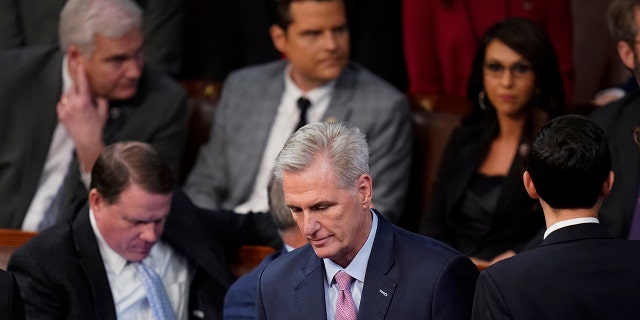 Rep. Kevin McCarthy, R-Calif., walks back to his seat after speaking with Rep. Matt Gaetz, R-Fla., after Gaetz voted "present" in the House chamber as the House meets for the fourth day to elect a speaker and convene the 118th Congress in Washington, Friday, Jan. 6, 2023. 