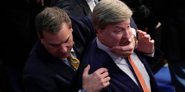 Rep. Richard Hudson, RN.C., left, pulls Rep. Mike Rogers, R-Ala., back as they talk with Rep. Matt Gaetz, R-Fla., and other during the 14th round of voting for speaker as the House meets for the fourth day to try and elect a speaker and convene the 118th Congress in Washington, Friday, Jan. 6, 2023. 