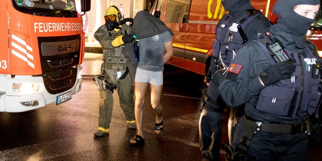 A man is taken into custody by a Special Operations Command in Castrop-Rauxel, Sunday, Jan. 8, 2023. 