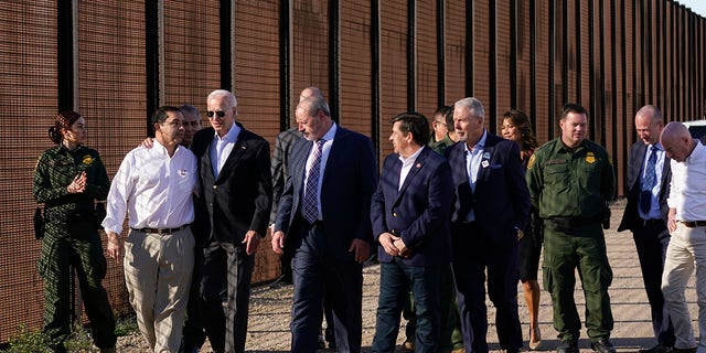 President Joe Biden talks with Rep. Henry Cuellar, D-Texas, second from left, as they walk along a stretch of the U.S.-Mexico border in El Paso Texas, Sunday, Jan. 8, 2023. 