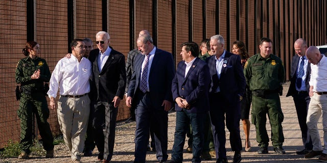 President Joe Biden talks with Rep. Henry Cuellar, D-Texas, second from left, as they walk along a stretch of the U.S.-Mexico border in El Paso Texas, Sunday, Jan. 8, 2023. 