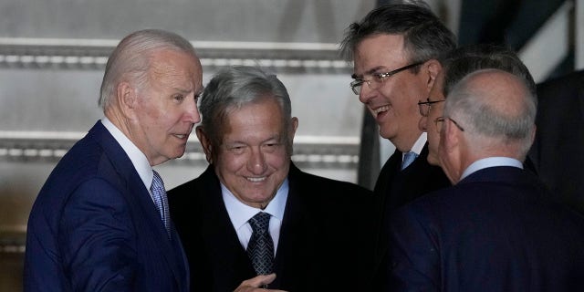 President Biden is greeted at his arrival by Mexican President Andres Manuel Lopez Obrador, second left, Mexican Foreign Minister Marcelo Ebrard, second right, and US Ambassador to Mexico Ken Salazar, right, at the Felipe Angeles international airport in Zumpango, Mexico, Sunday, Jan 8, 2023. 