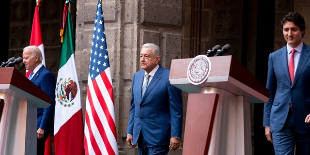 From left, President Biden, Mexican President Andres Manuel Lopez Obrador and Canadian Prime Minister Justin Trudeau arrive for a news conference at the 10th North American Leaders' Summit at the National Palace in Mexico City on Tuesday.