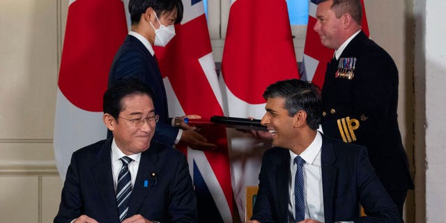 Britain's Prime Minister Rishi Sunak smiles at Japan's Prime Minister Fumio Kishida after they signed a defense agreement at the Tower of London, Wednesday, Jan. 11, 2023.