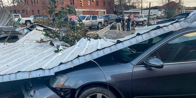 A damaged vehicle and debris are seen in the aftermath of severe weather, Thursday, Jan. 12, 2023, in Selma, Ala. 