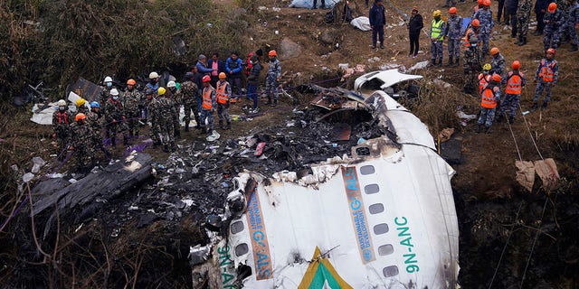 Rescuers scour the crash site in the wreckage of a passenger plane in Pokhara, Nepal, Monday, Jan.16, 2023. 