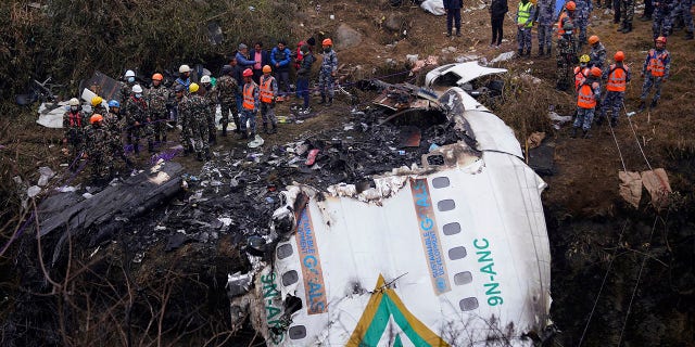 Rescuers scour the crash site in the wreckage of a passenger plane in Pokhara, Nepal, Monday, Jan.16, 2023. 