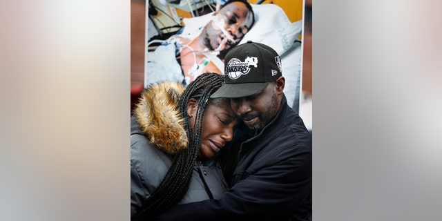 Kenyana Dixon is comforted during a rally for her brother Tyre Nichols at the National Civil Rights Museum on Monday, Jan. 16, 2023.
