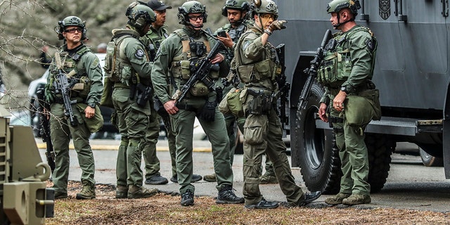 DeKalb, Ga., and Atlanta SWAT members are pictured leaving the Gresham Park command post in Atlanta on Wednesday, Jan. 18, 2023. 