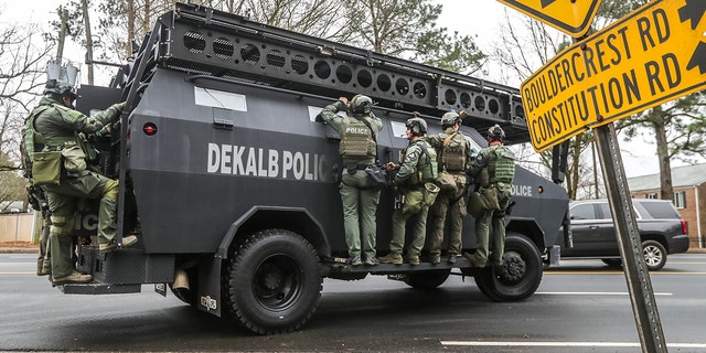 DeKalb, Ga., and Atlanta SWAT members are pictured leaving the Gresham Park command post in Atlanta on Wednesday, Jan. 18, 2023. 