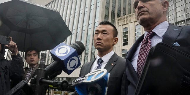 NYPD Officer Baimadajie Angwang, left, and his attorney, John Carman, hold a press briefing after a judge dismissed spy charges against him on Thursday, Jan. 19, 2023, in New York.