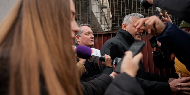 US Embassy General Consul in Romania, John Gimbel, center left, exits a police detention center in downtown Bucharest, Romania, Friday, Jan. 20, 2023.