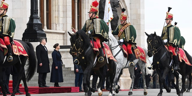 Hungarian President Katalin Novak, right, receives Croatian President Zoran Milanovic, left, with military honours at the parliament building in Budapest, Hungary, Friday, Jan. 20, 2023.