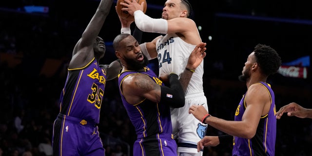 Memphis Grizzlies forward Dillon Brooks (24) fouls Los Angeles Lakers forward LeBron James (6) during the first half of an NBA basketball game in Los Angeles, Friday, Jan. 20, 2023. 
