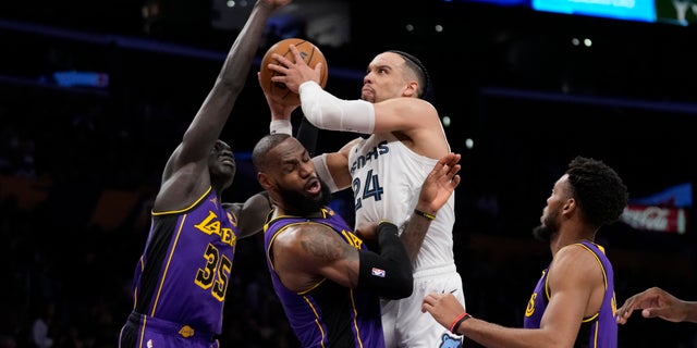 Memphis Grizzlies forward Dillon Brooks (24) fouls Los Angeles Lakers forward LeBron James (6) during the first half of an NBA basketball game in Los Angeles, Friday, Jan. 20, 2023.