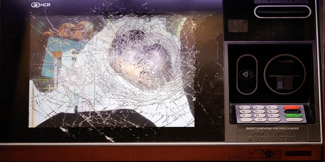 A smashed ATM is seen at a Wells Fargo branch following a protest, late Saturday, Jan. 21, 2023, in Atlanta, in the wake of the death of an environmental activist killed after authorities said the 26-year-old shot a state trooper. 