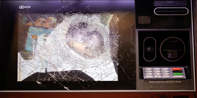 A smashed ATM is seen at a Wells Fargo branch following a protest, late Saturday, Jan. 21, 2023, in Atlanta, in the wake of the death of an environmental activist killed after authorities said the 26-year-old shot a state trooper.