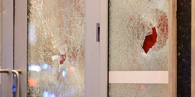 Broken windows at a Wells Fargo branch are seen following a protest, Saturday, Jan. 21, 2023, in Atlanta.