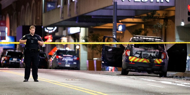 A police officer blocks a downtown street following a protest, Saturday, Jan. 21, 2023, in Atlanta, in the wake of the death of an environmental activist killed after authorities said the 26-year-old shot a state trooper. 