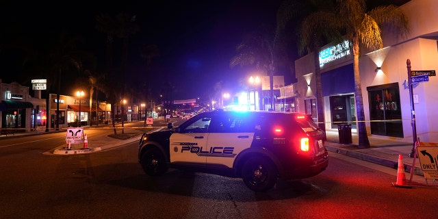 A police vehicle is seen near a scene where a shooting took place in Monterey Park, Calif., Sunday, Jan. 22, 2023. Dozens of police officers responded to reports of a shooting that occurred after a large Lunar New Year celebration had ended in a community east of Los Angeles late Saturday. 