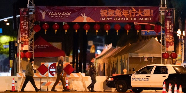 FBI agents walk near a scene where a shooting took place in Monterey Park, Calif., Sunday, Jan. 22, 2023.