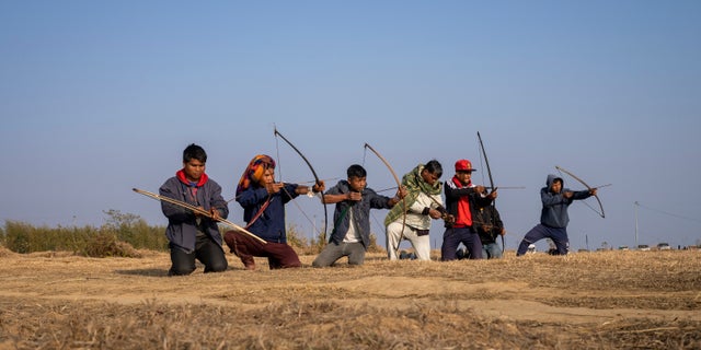 A group of local men practice archery on a ridge about 12 miles from Shillong, India, on Jan. 22, 2023.