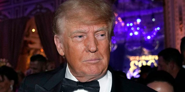 Former President Donald Trump arrives for a New Year's Eve party at Mar-a-Lago, in Palm Beach, Fla., Dec. 31, 2022. 