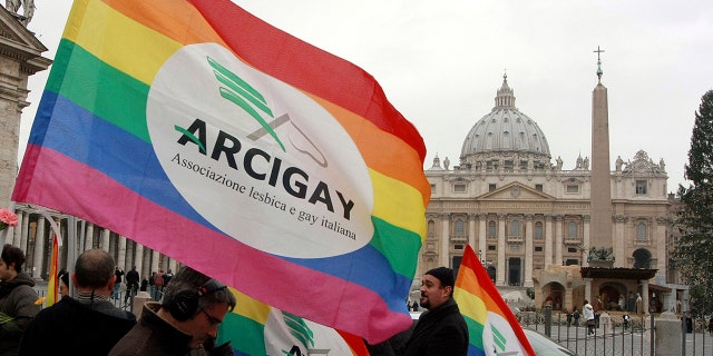 Italian Arcigay gay rights association activists hold banners and flags during a demonstration in front of The Vatican, Tuesday, Jan. 13, 2009.