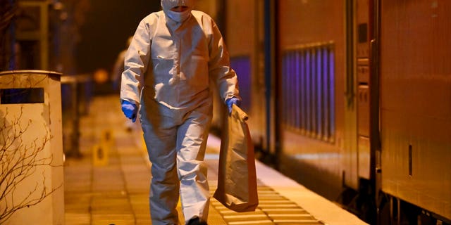 Forensics staff are shown at a train platform in Brokstedt, Germany, Jan. 25, 2023. German police say a man fatally stabbed two people and injured seven others on a train before police finally arrested him.