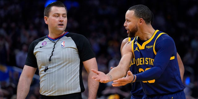 Golden State Warriors guard Stephen Curry, right, reacts after being charged with a technical foul during the second half of the team's NBA basketball game against the Memphis Grizzlies in San Francisco, Wednesday, Jan. 25, 2023. Curry was ejected. 