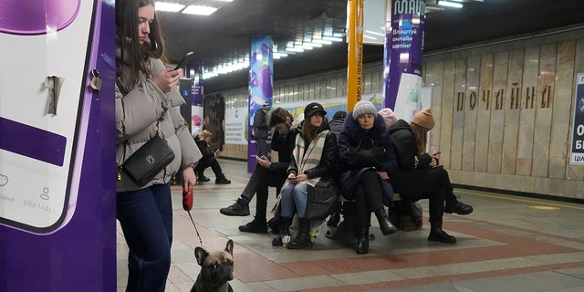 People gather in a subway station being used as a bomb shelter during a rocket attack in Kyiv, Ukraine, Thursday, Jan. 26, 2023. 