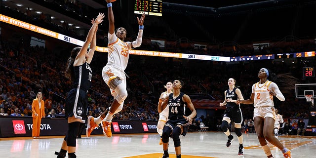 Tennessee guard Jordan Horston, #25, shoots past UConn guard Nika Muhl, #10, during the second half of an NCAA college basketball game, Thursday, Jan. 26, 2023, in Knoxville, Tennessee.