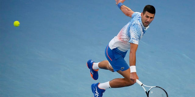 Novak Djokovic of Serbia plays a backhand return to Tommy Paul of the U.S. during their semifinal at the Australian Open tennis championship in Melbourne, Australia, Friday, Jan. 27, 2023.