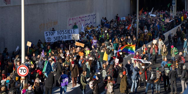 Extinction Rebellion activists and sympathisers block a busy road in The Hague, Netherlands, Saturday, Jan. 28, 2023. Earlier this week seven Extinction Rebellion activists were detained by authorities for sedition linked to the protest. 