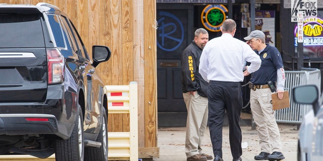 Investigators are seen outside of Reggie’s bar in Baton Rouge, Louisiana, on Tuesday, January 24, 2023. The bar is reportedly one of the last places where LSU student Madison Brooks was seen before her death on January 15.