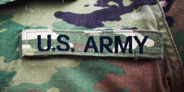 US Army badge on camouflage uniform