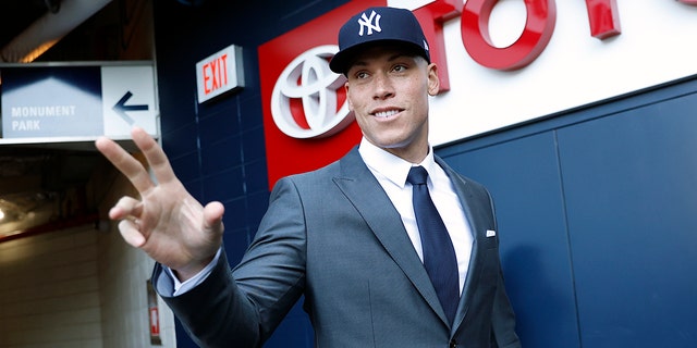 Aaron Judge #99 of the New York Yankees waves to fans after a press conference at Yankee Stadium on December 21, 2022, in the Bronx, New York.