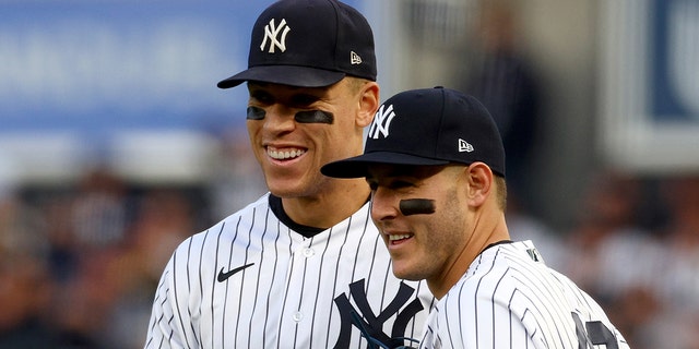 Aaron Judge, #99, and Anthony Rizzo, #48 of the New York Yankees, react after the first out was recorded against the Houston Astros during the second inning in game three of the American League Championship Series at Yankee Stadium on Oct. 22, 2022 in New York City.