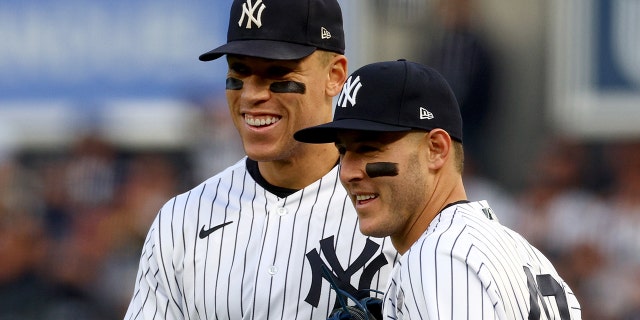 Aaron Judge, #99, and Anthony Rizzo, #48 of the New York Yankees, react after the first out was recorded against the Houston Astros during the second inning in game three of the American League Championship Series at Yankee Stadium on Oct. 22, 2022 in New York City.